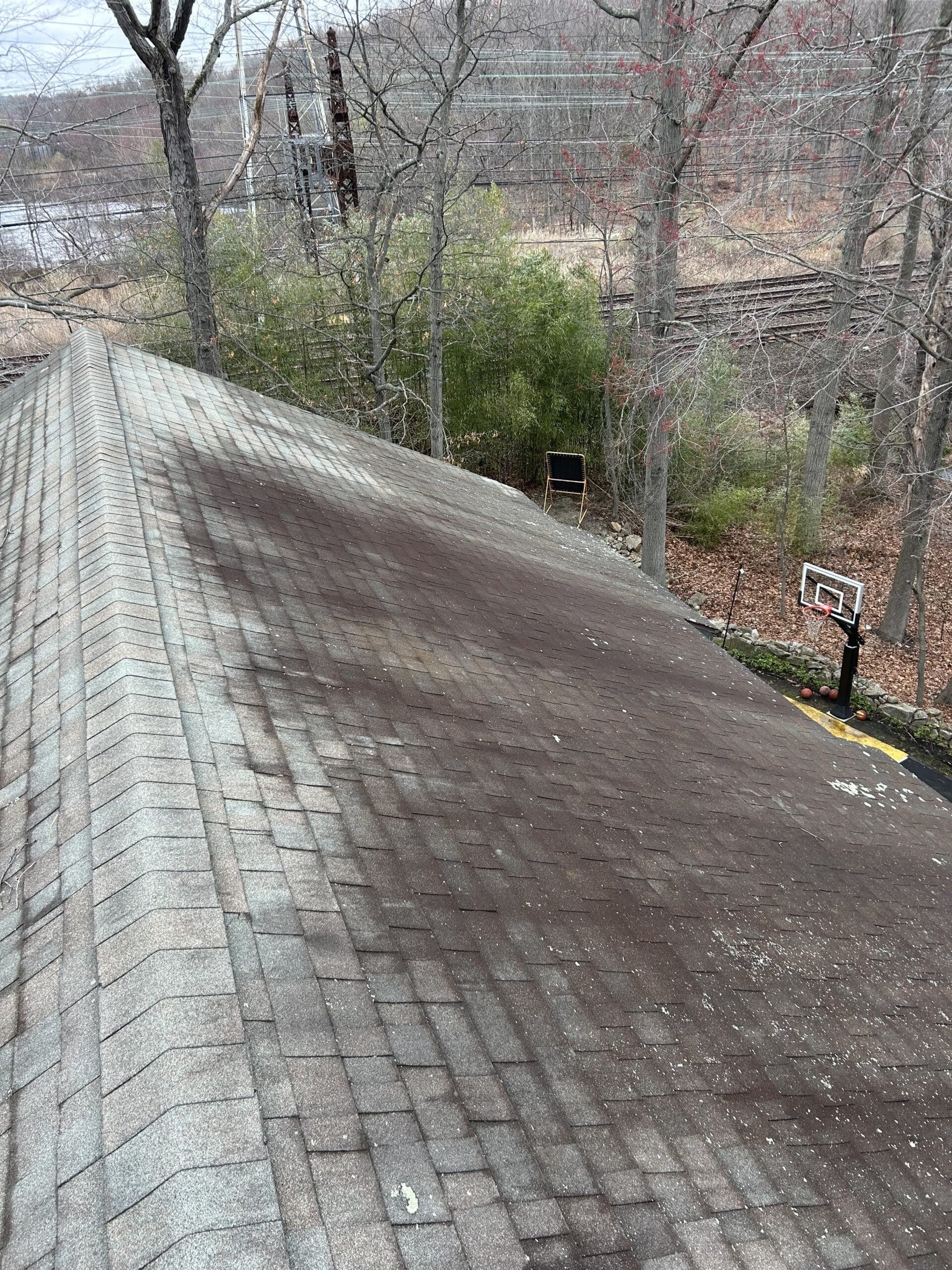 Asphalt roof shingles before soft washing in Westport, CT